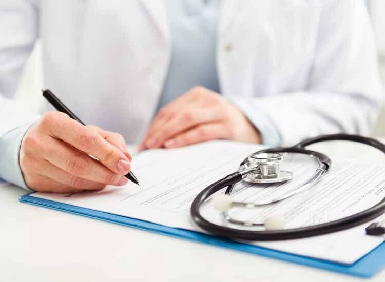 Internal medicine consultation — physician reviewing medical records with stethoscope